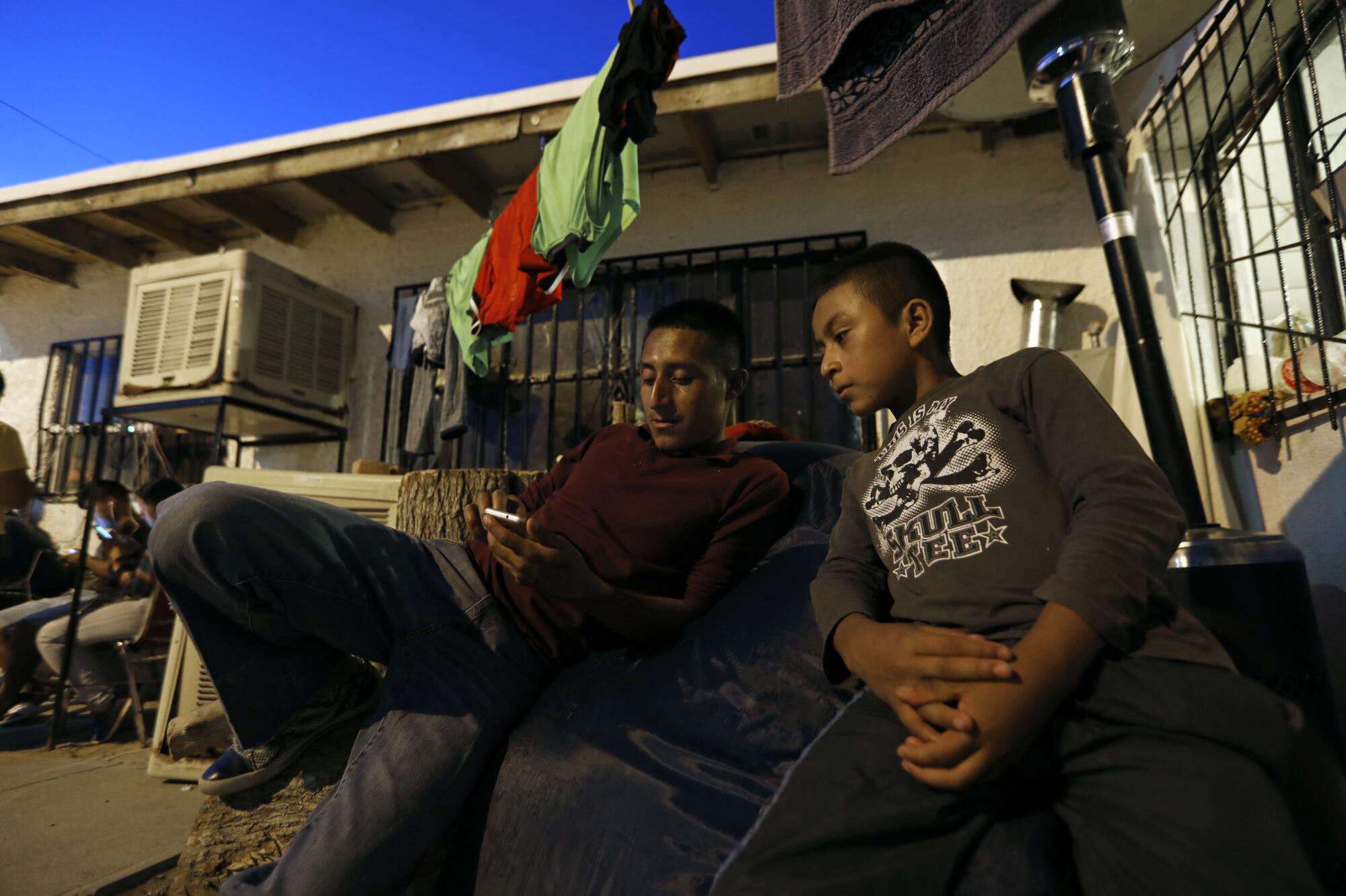 Fredy Augusto Burrion at Buen Pastor shelter in Juarez, Mexico, with his son Jhostin.