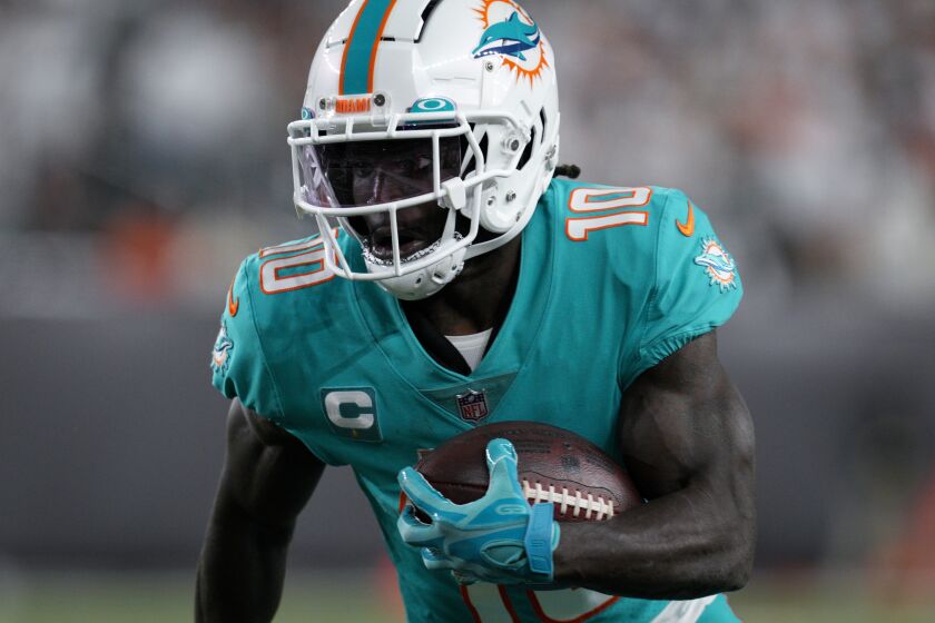 Miami Dolphins wide receiver Tyreek Hill (10) makes a catch during an NFL football game against the Cincinnati Bengals, Friday, Sept. 30, 2022, in Cincinnati. (AP Photo/Jeff Dean)