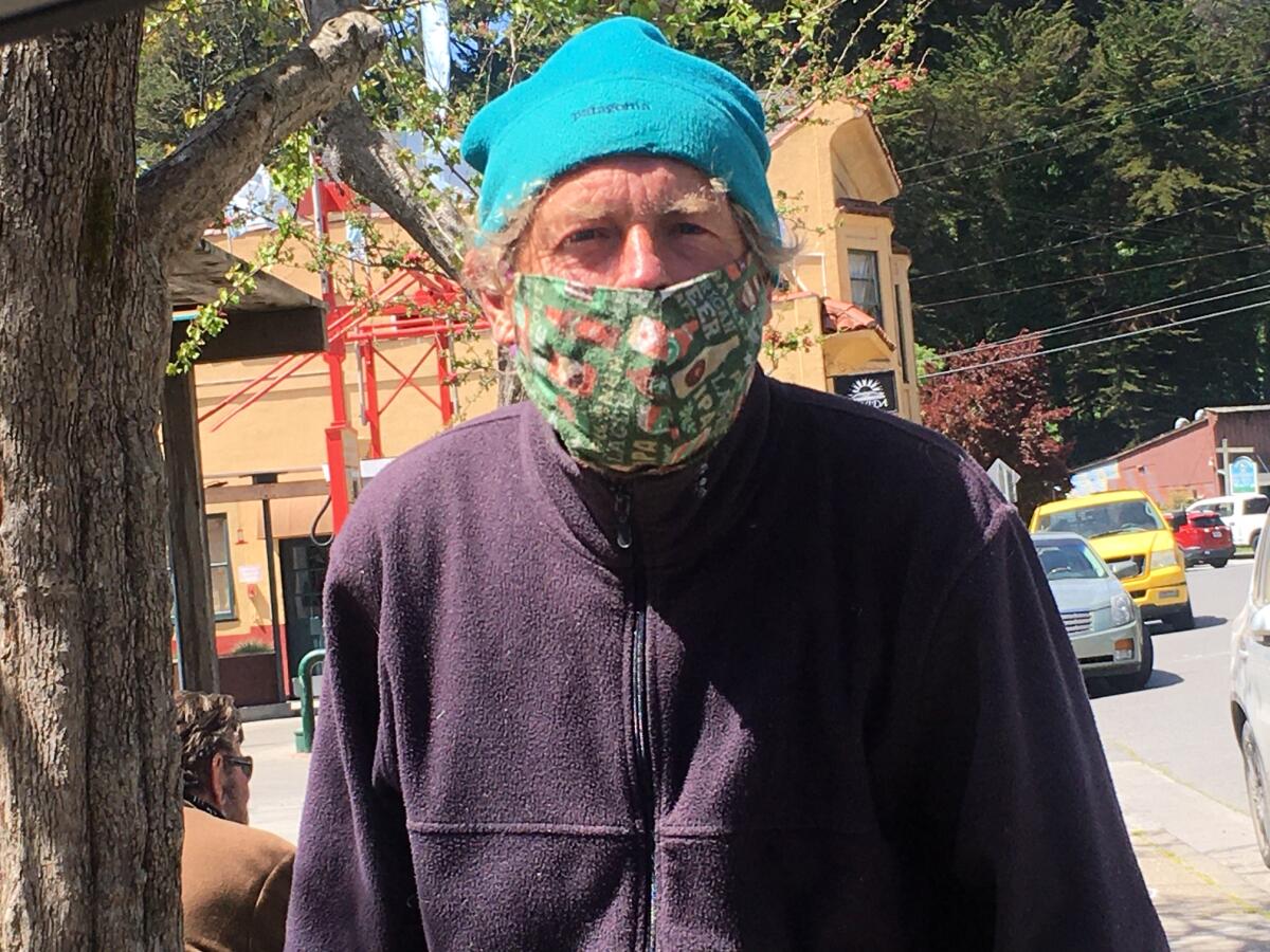 Bruce Dark, a Bolinas resident, calls the pandemic "mass hysteria" but still wears a mask.