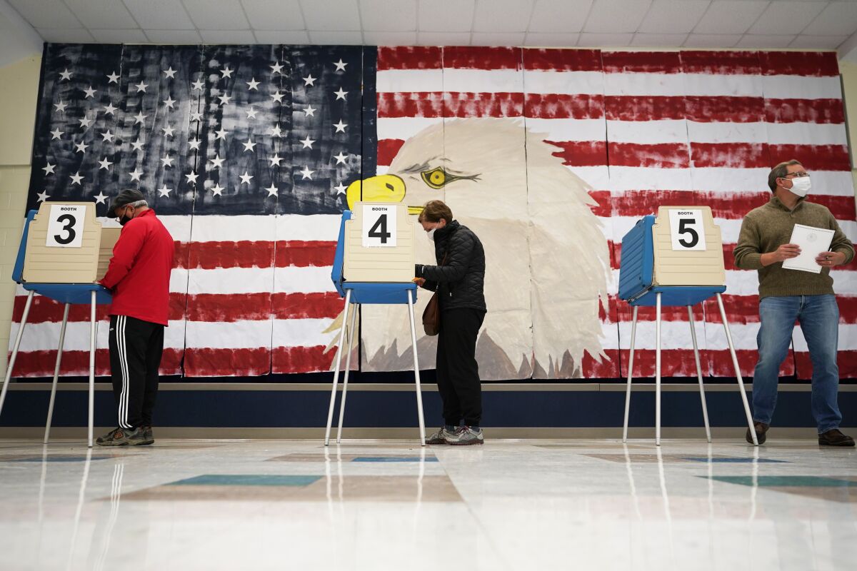 CORRECTS MONTH TO NOVEMBER Voters cast their ballots under a giant mural at Robious Elementary school in Midlothian, Va., Tuesday Nov. 3, 2020. Poll workers said that traffic was slow due to all the early voting in the precinct. (AP Photo/Steve Helber)