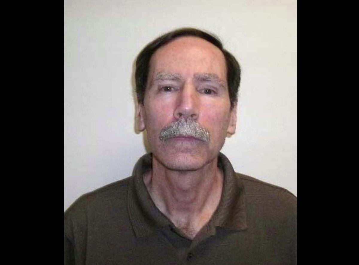 Close-up of a man with a receding hairline and graying eyebrows and mustache.