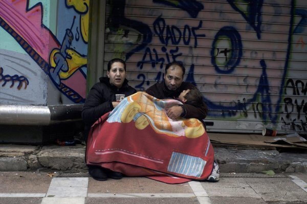 A family begs at Stadiou Street in Athens. The number of homeless in Athens is rising rapidly since 2009 as Greece struggles to deal with its debt crisis.