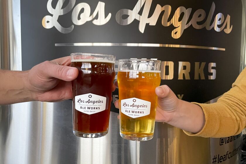 Friends cheers a couple of beers at the Los Angeles Ale Works tasting room