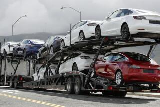 A truck loaded with Tesla cars departs the Tesla plant Tuesday, May 12, 2020, in Fremont, Calif. Tesla CEO Elon Musk has emerged as a champion of defying stay-home orders intended to stop the coronavirus from spreading, picking up support as well as critics on social media. Among supporters was President Donald Trump, who on Tuesday tweeted that Tesla's San Francisco Bay Area factory should be allowed to open despite health department orders to stay closed except for basic operations. (AP Photo/Ben Margot)