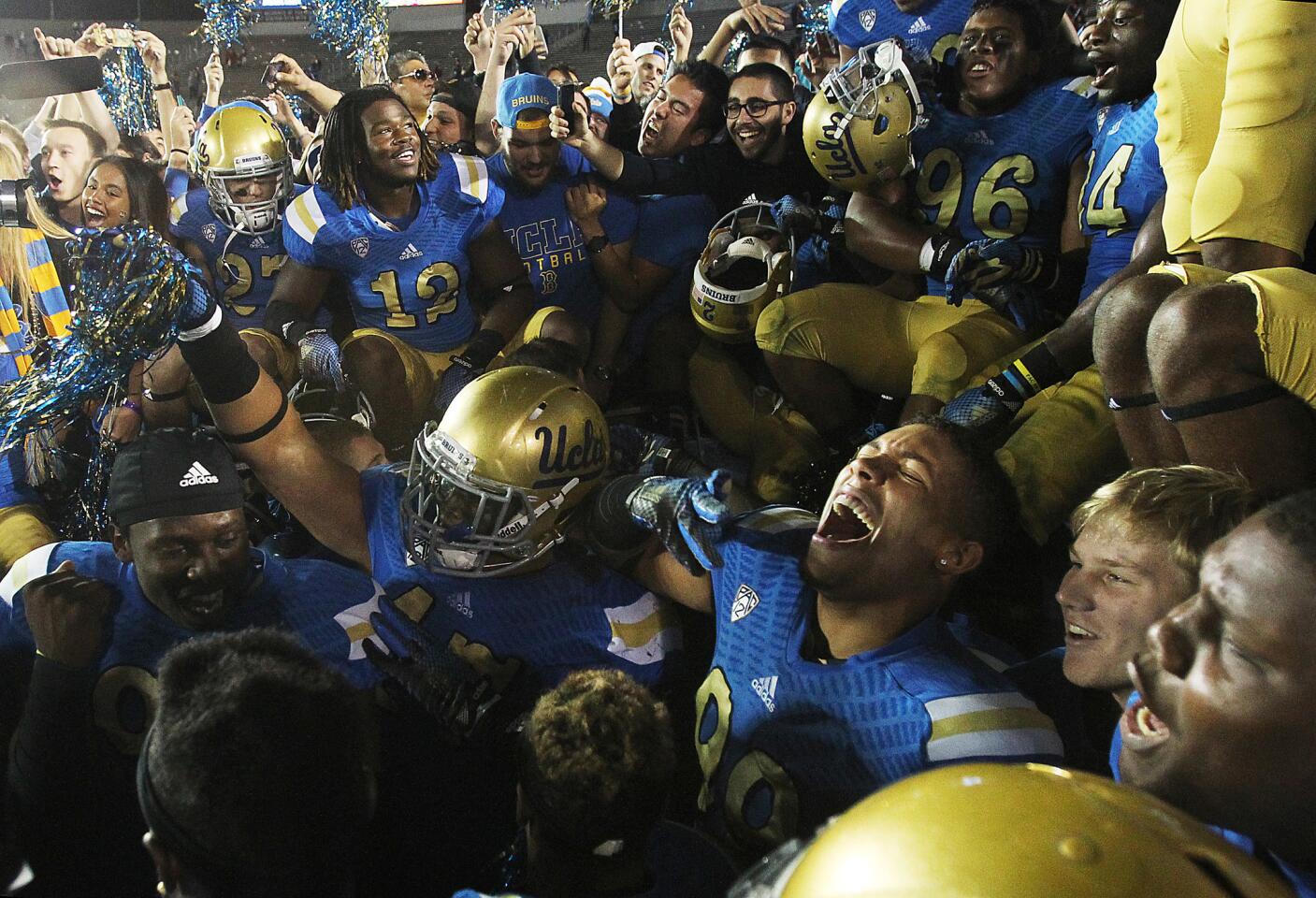 UCLA players celebrate a 38-20 win over USC on Saturday night at the Rose Bowl.