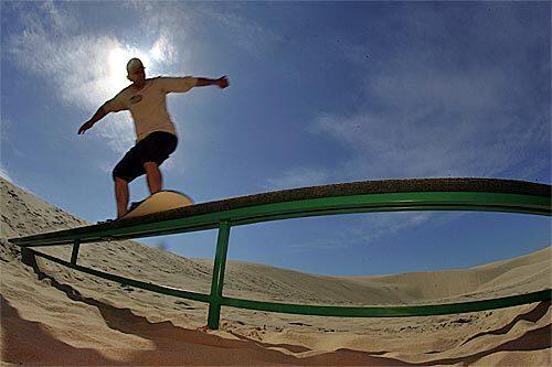 Josh Tenge gives new meaning to the expression "riding the rails" as he glides on a sandboard in Florence, Ore. Tenge is exhibiting his skill at Sand Master Park, the nation's first sandboarding park, at the north end of the nation's largest expanse of coastal dunes. The area is a natural for sandboarding, a simple, relatively inexpensive pastime -- all you really need is a board and a dune; you can ride in shorts and T-shirt, no need for helmet or padding -- that offers an adrenaline jolt.