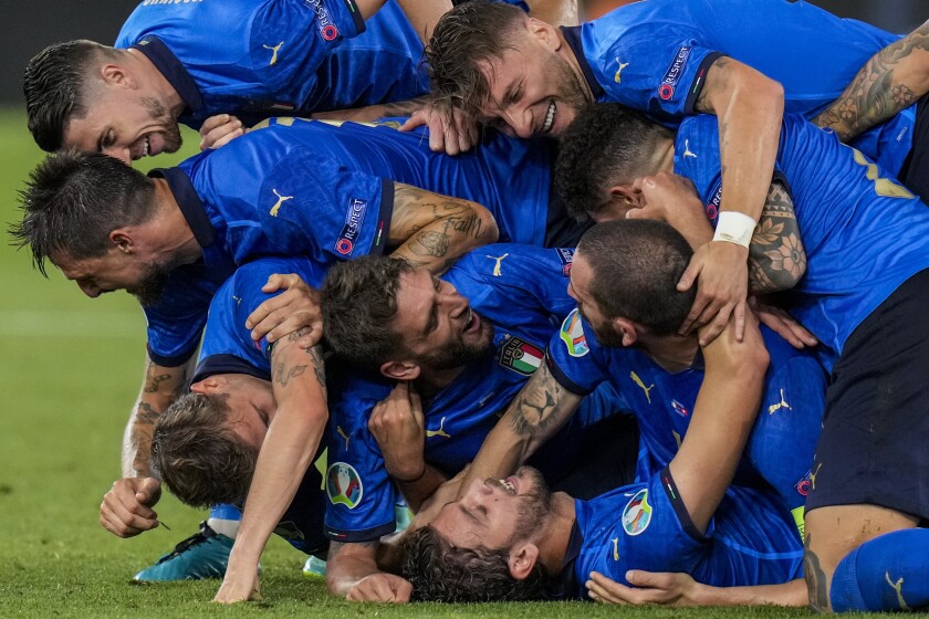 Italy players celebrate their second goal during the Euro 2020 soccer championship group A match between Italy and Switzerland at the Olympic stadium in Rome, Italy, Wednesday, June 16, 2021. (AP Photo/Alessandra Tarantino, Pool)