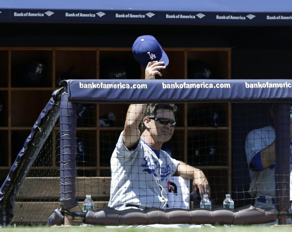 Dodgers Manager Don Mattingly, a beloved former Yankee player, acknowledges the crowd at Yankee Stadium during Wednesday's game.