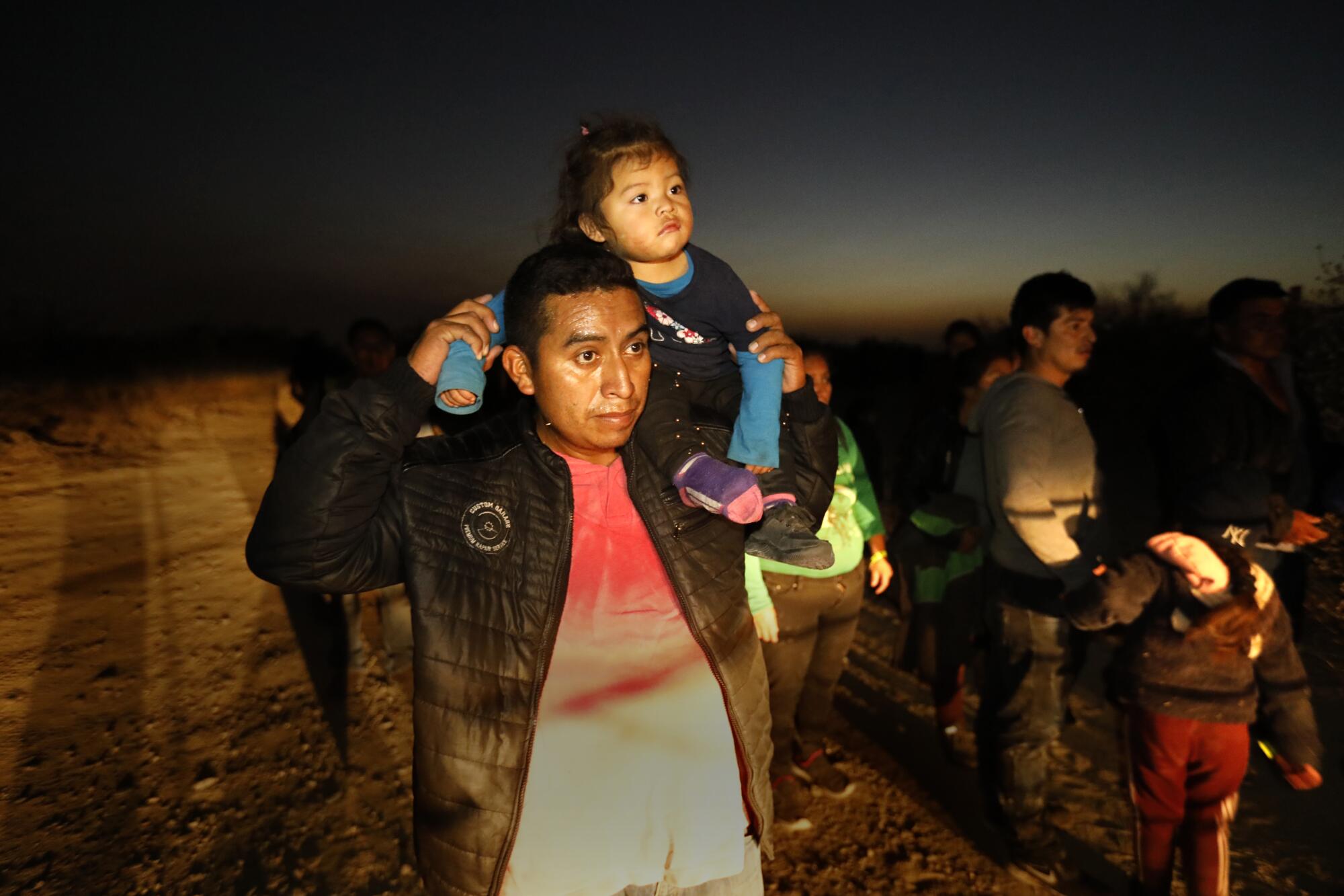  An asylum seeker carries a child 
