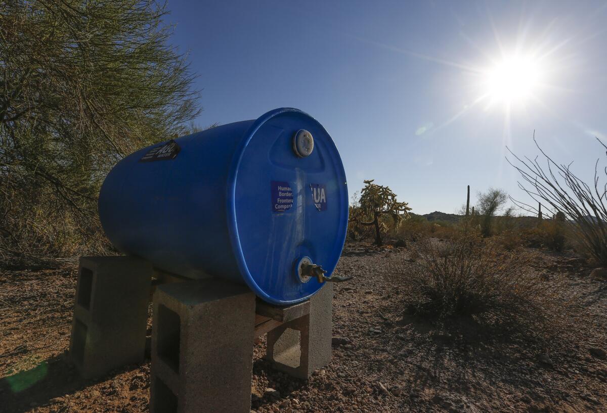 Humanitarian groups have placed blue tanks of water to aid immigrants crossing the desert in Organ Pipe National Monument.