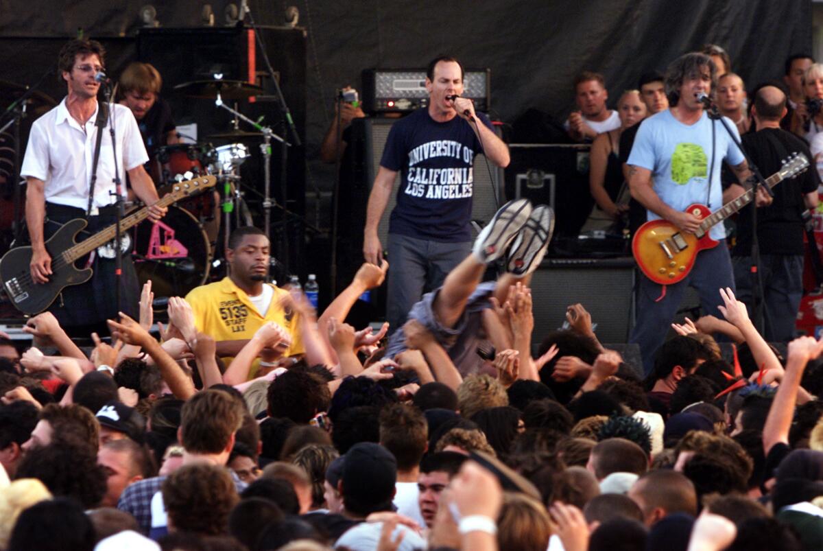 Bad Religion, a surfing fan and security at Warped Tour at the Sports Arena in Los Angeles.