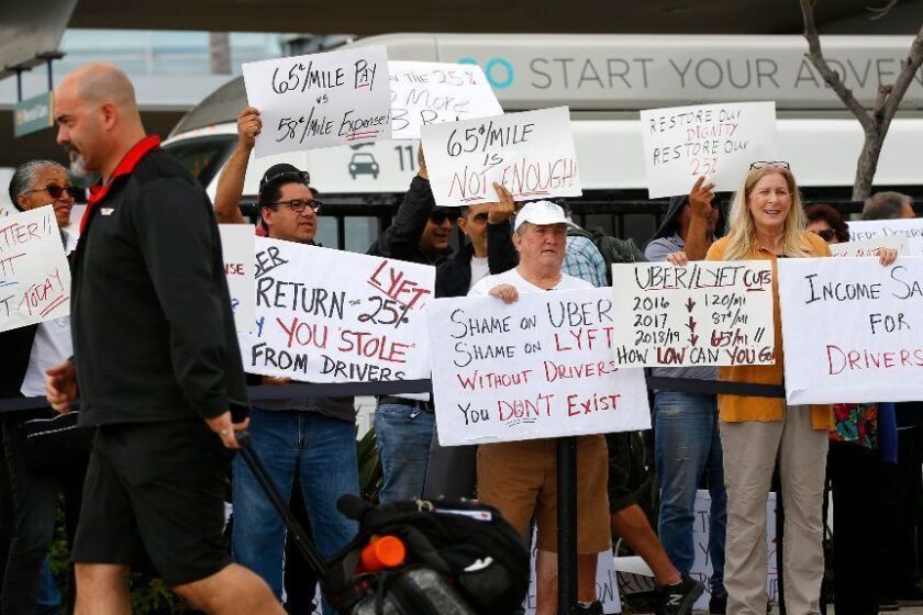 Uber and Lyft drivers picket at San Diego International Airport during a 24-hour strike in an effort to demand better pay and treatment from the tech giants on May 7, 2019. (K.C. Alfred/The San Diego Union-Tribune/TNS) ** OUTS - ELSENT, FPG, TCN - OUTS **