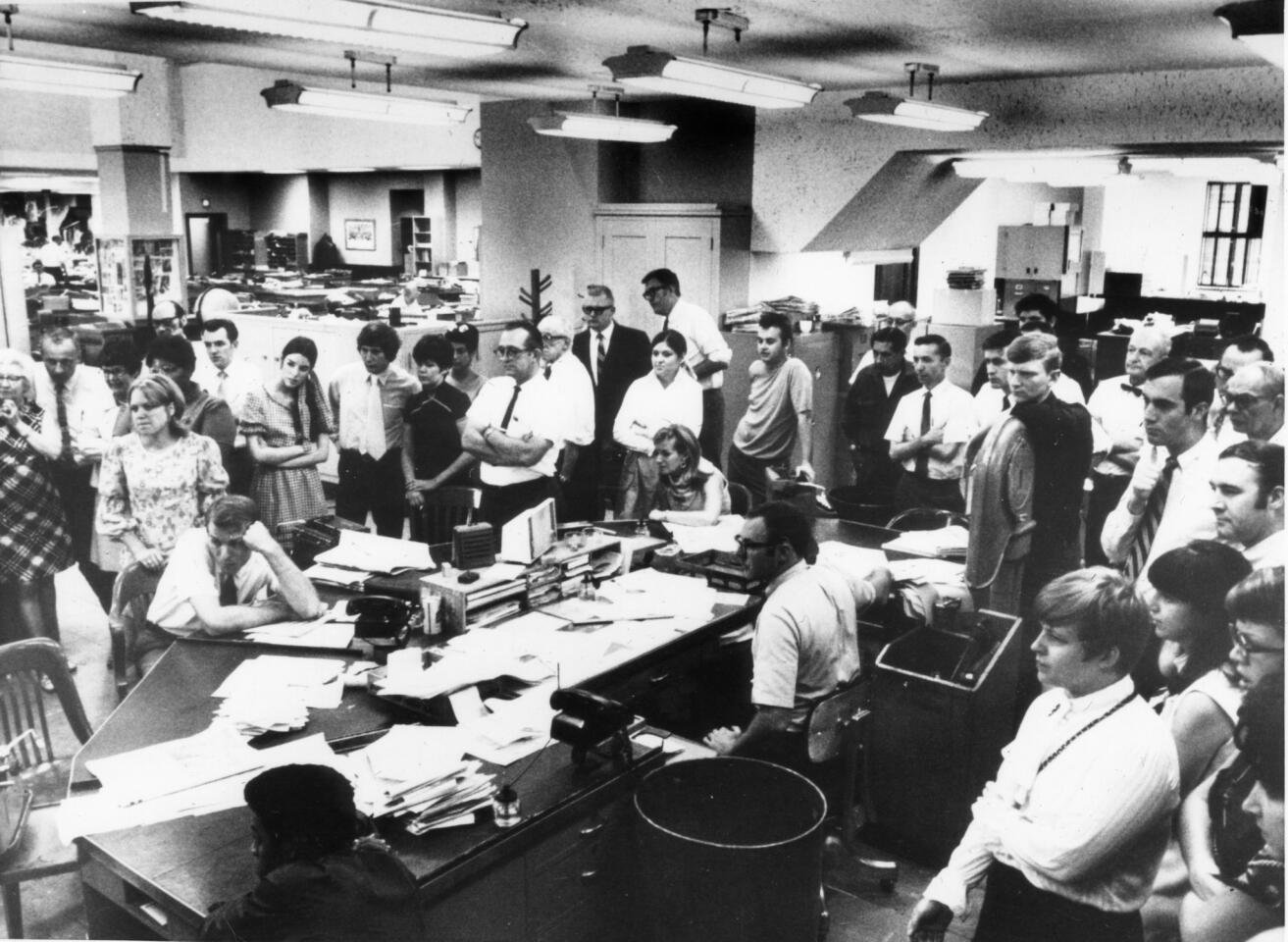 Chicago Tribune editorial staffers watch the splashdown of the Apollo capsule on television from the fourth-floor newsroom at the Tribune Tower on July 24, 1969.