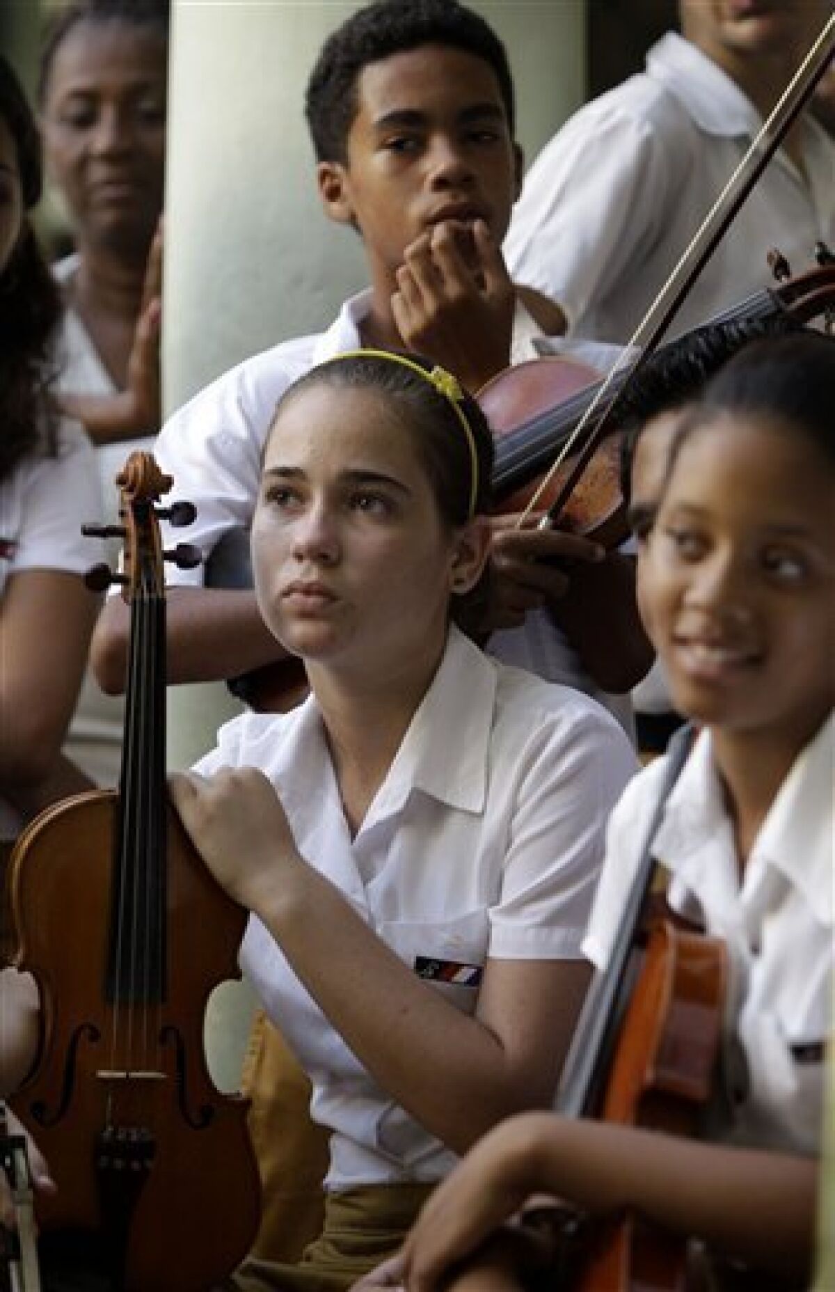 Students meet with members of the Jazz at Lincoln Center at the Conservatory School Guillermo Tomas in Havana, Cuba, Wednesday, Sept. 7, 2011. Jazz at Lincoln Center returned to the Caribbean island with instruments to be donated to four designated music schools and a group of talented musicians and luthiers who will impart workshops to students and also repair their damaged instruments on a week-long visit. (AP Photo/Javier Galeano)
