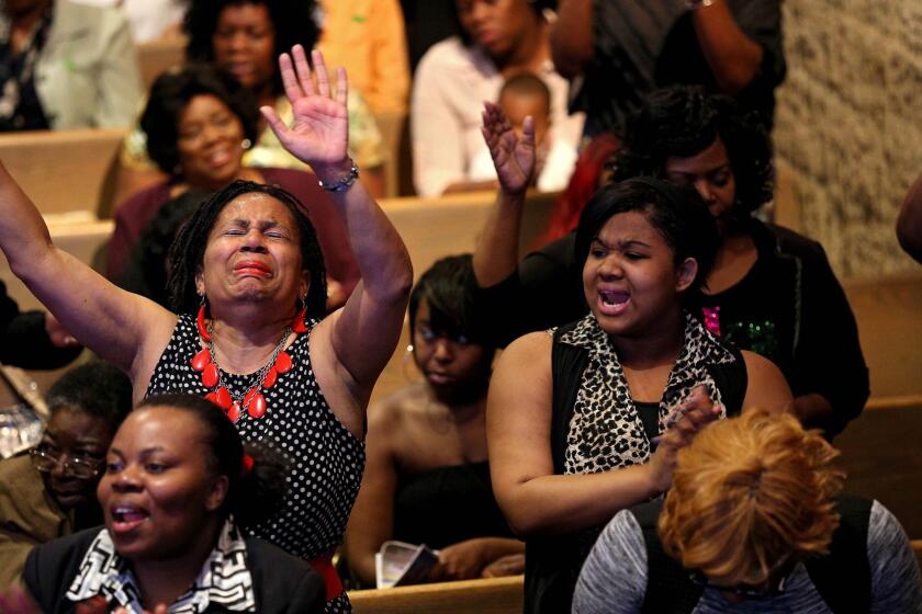 Church members sing and pray at the Southern Baptist Church with pastor Dr. Donte L. Hickman Sr., (not pictured) two days after Baltimore authorities released a report on the death of Freddie Gray on May 3, 2015 in Baltimore. Maryland Gov., Larry Hogan called for a statewide "Day of Prayer and Peace" on Sunday.