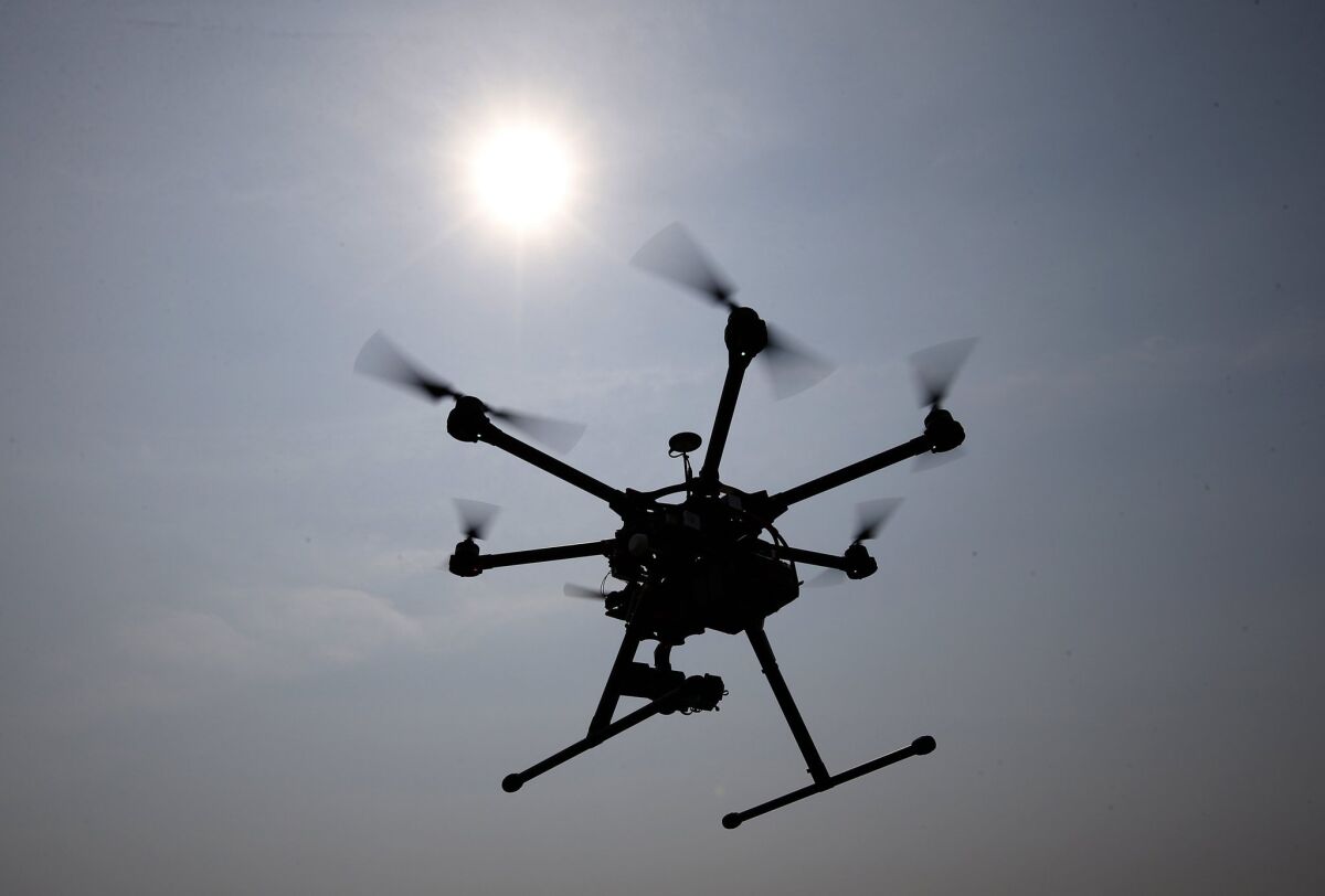 A hexacopter drone hovers over Cordova, Md., on June 11, 2015. A man was arrested July 15 on suspicion of flying a drone over a fire.