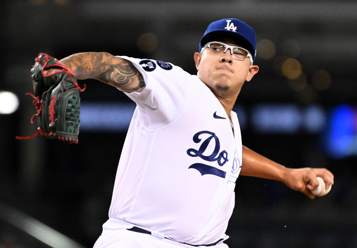 Dodgers pitcher Julio Urías throws a pitch against the Colorado Rockies in the third inning at Dodger Stadium.