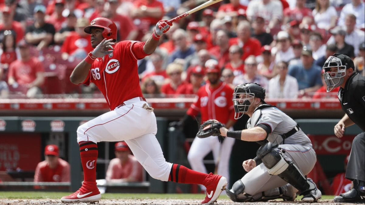 Yasiel Puig hits a two-run double for the Cincinnati Reds against the Miami Marlins on April 11.