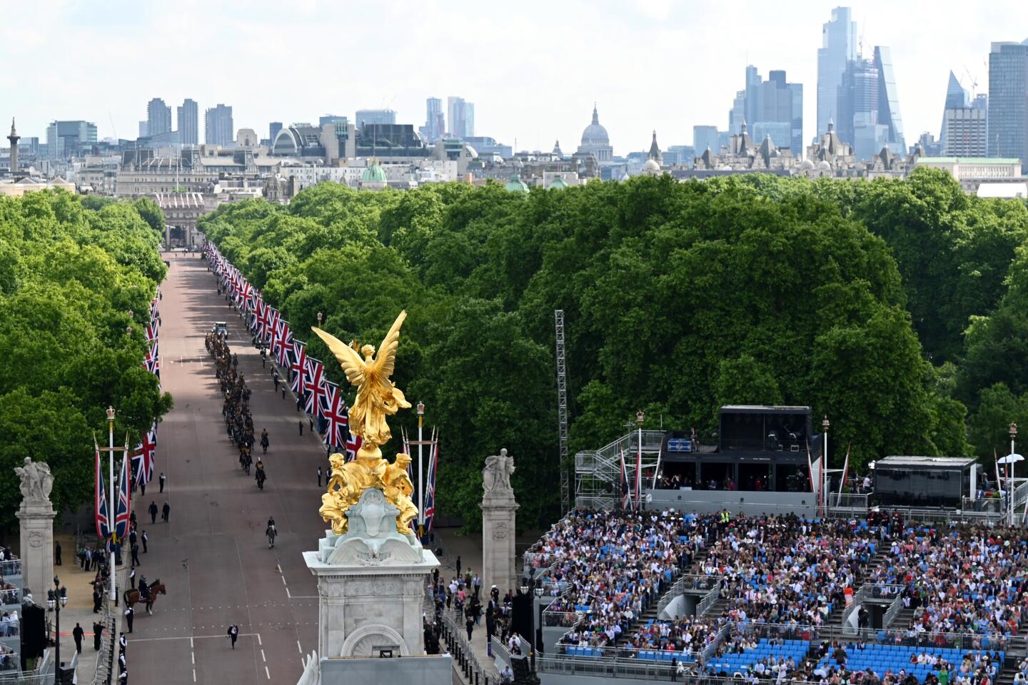 Members of the public watch from stands on the Mall during the queen's birthday parade.