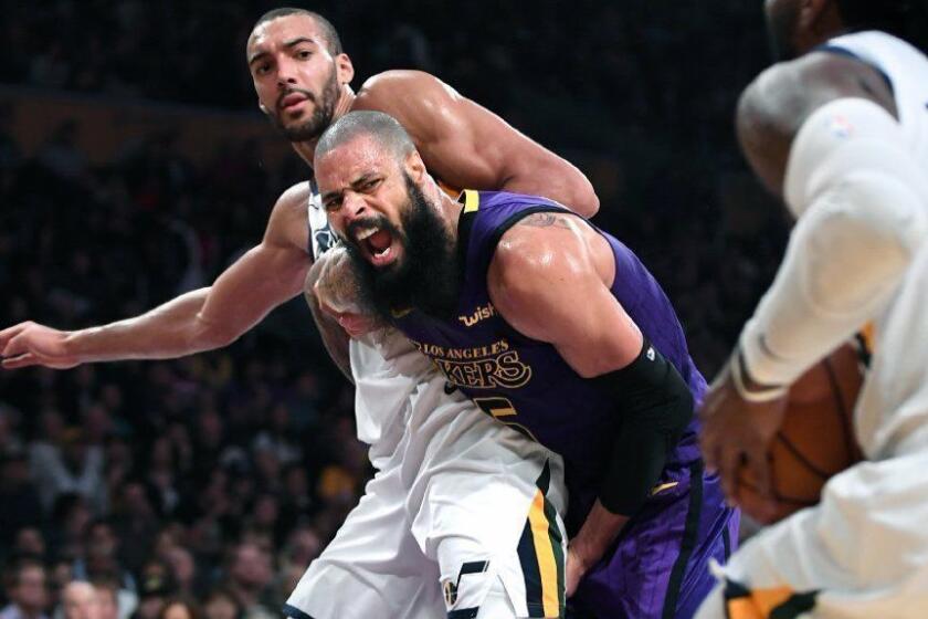 LOS ANGELES, CALIFORNIA NOVEMBER 23, 2018-Lakers Tyson Chandler and Jazz Rudy Gobert battle for position as Jae Crowder drives to the bakset in the 3rd quarter at the Staples Center Friday. (Wally Skalij/Los Angeles Times)
