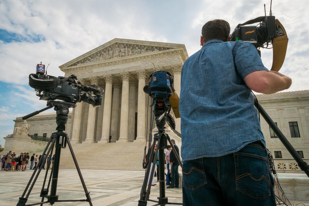 Video journalists set up outside the Supreme Court in Washington.