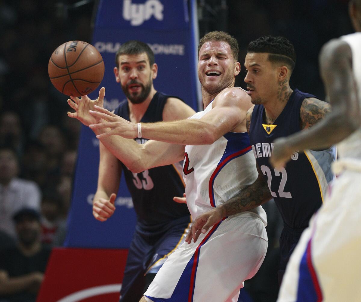 Clippers power forward Blake Griffin tries to get off a pass in-between the defense of Grizzlies center Marc Gasol (33) and forward Matt Barnes (22) in the first half.