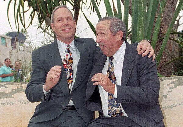 Michael Eisner, former chairman and CEO of the Walt Disney Co., shares a light moment with Roy E. Disney during dedication ceremonies for the Animal Kingdom theme park in Florida in 1998. Disney later called on shareholders to cast a vote of no-confidence in Eisner, saying the top executive's leadership had led to the perception of the company as "rapacious, soul-less and always looking for the 'quick buck' rather than long-term value."