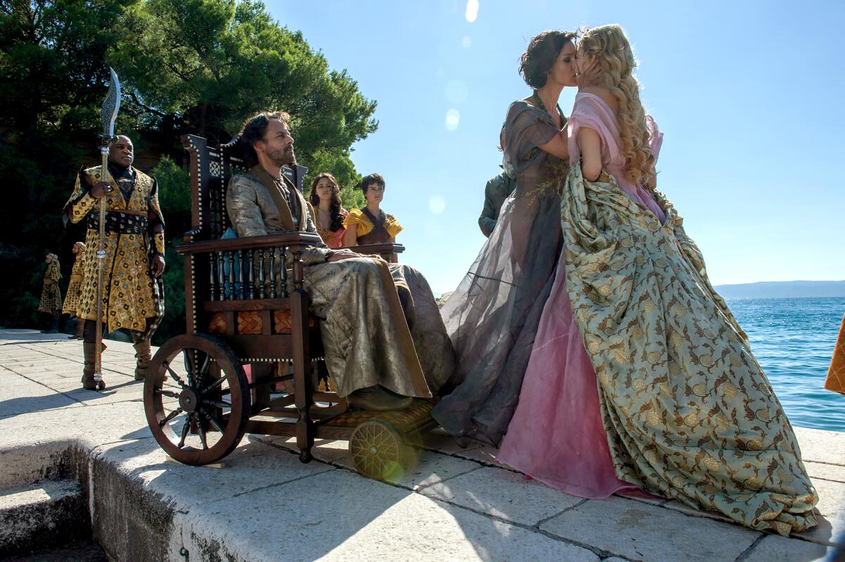 Deobia Oparei and Alexander Siddig's characters watch as Indira Varma and Nell Tiger Free kiss in "Game of Thrones."