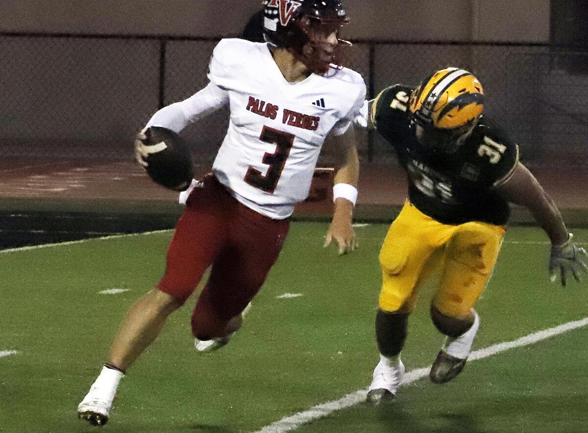 Edison's Matt Lopez (31) rushes Palos Verdes quarterback Ryan Rakowski (3) in a nonleague game on Friday.