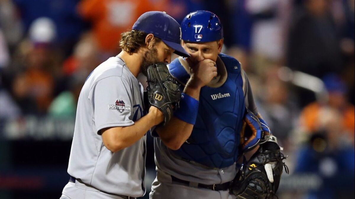 Dodgers ace Clayton Kershaw and catcher A.J. Ellis talk during Game 4 of the National League Division Series against the Mets on Oct. 13, 2015.