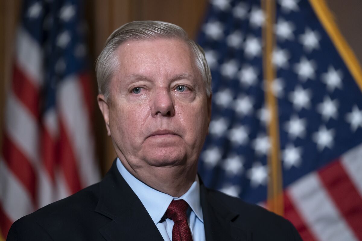 FILE - Sen. Lindsey Graham, R-S.C., the ranking member of the Senate Budget Committee, waits to speak to reporters following bi-partisan passage of the Ending Forced Arbitration of Sexual Assault and Sexual Harassment Act, at the Capitol in Washington, Feb. 10, 2022. Graham is among a handful of Republicans declaring a willingness to back President Joe Biden's nominee to the Supreme Court. Graham has been promoting U.S. District Judge Michelle Childs as his preferred choice to replace the retiring Justice Stephen Breyer. (AP Photo/J. Scott Applewhite, File)