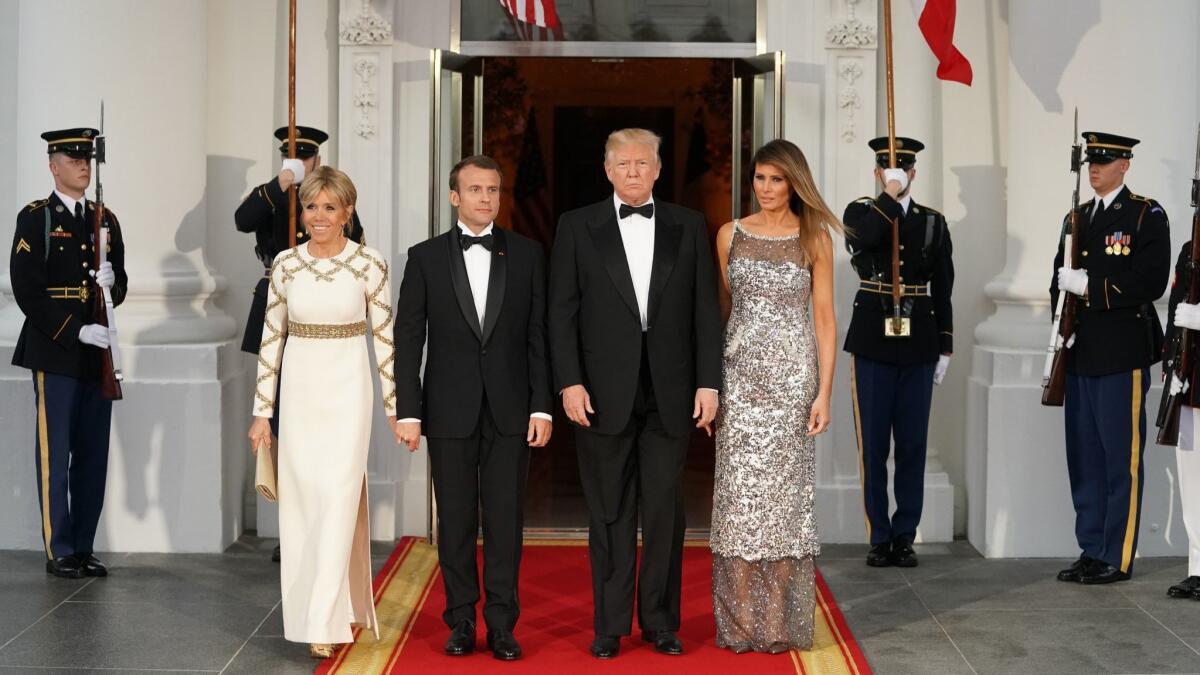 French President Emmanuel Macron’s wife Brigitte Macron, left, wears Louis Vuitton, and First Lady Melania Trump wears Chanel for Tuesday’s state dinner at the White House.