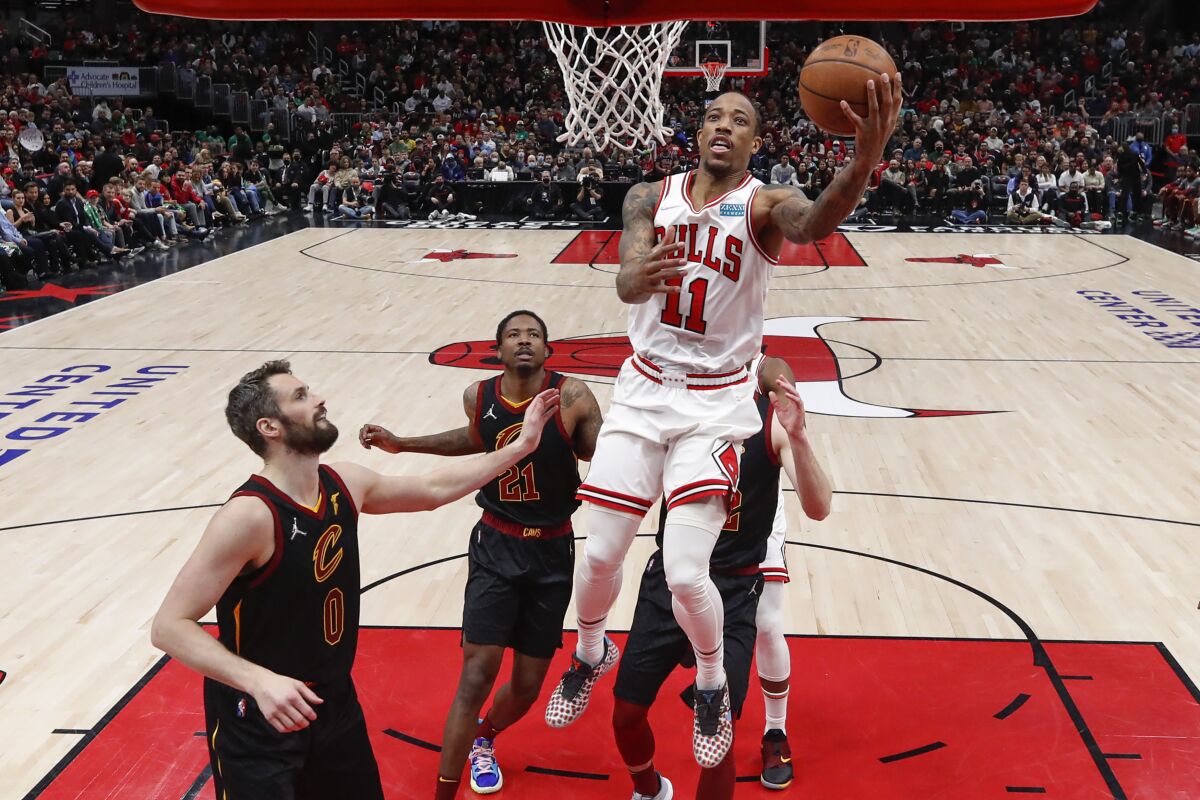 Chicago Bulls forward DeMar DeRozan (11) goes to the basket against the Cleveland Cavaliers during the first half of an NBA basketball game, Saturday, March 12, 2022, in Chicago. (AP Photo/Kamil Krzaczynski)