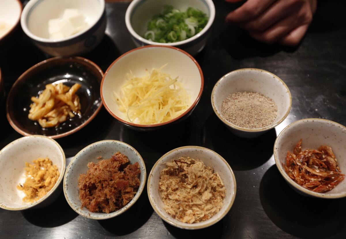 Some of the different items that will go into a seafood congee are lined up on the counter prior to preparation.