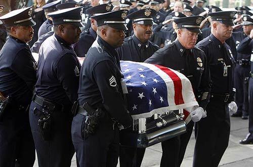 Los Angeles Police Department members carry the casket of Deputy Chief Kenneth O. Garner into the Crenshaw Christian Center in Los Angeles.