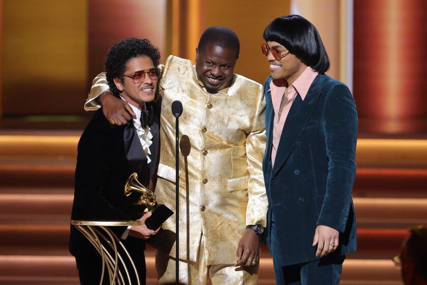 LAS VEGAS, NEVADA - APRIL 03: (L-R) Bruno Mars, Dernst Emile II, and Anderson .Paak accept the Song Of The Year award for ‘Leave The Door Open’ onstage during the 64th Annual GRAMMY Awards at MGM Grand Garden Arena on April 03, 2022 in Las Vegas, Nevada. (Photo by Rich Fury/Getty Images for The Recording Academy)