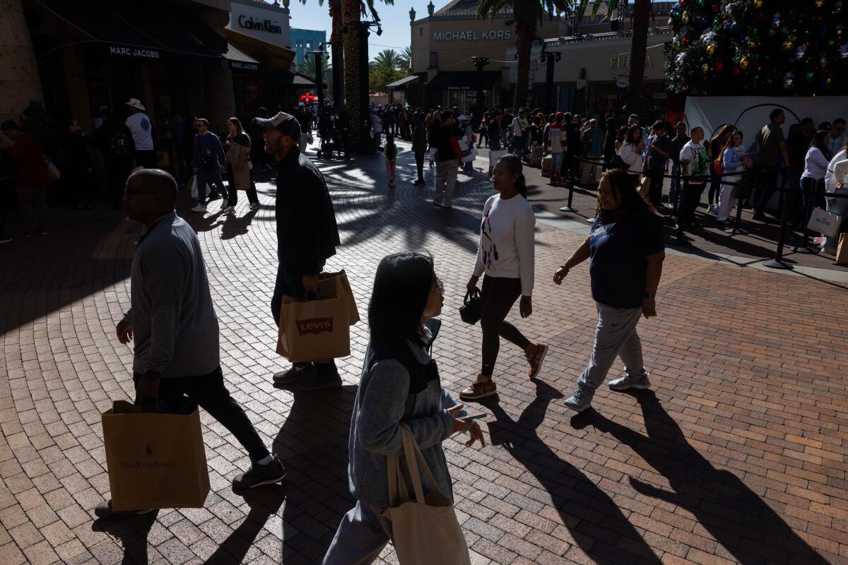 Shoppers walk through the Citadel Outlets on Nov. 28, 2025, in City of Commerce.