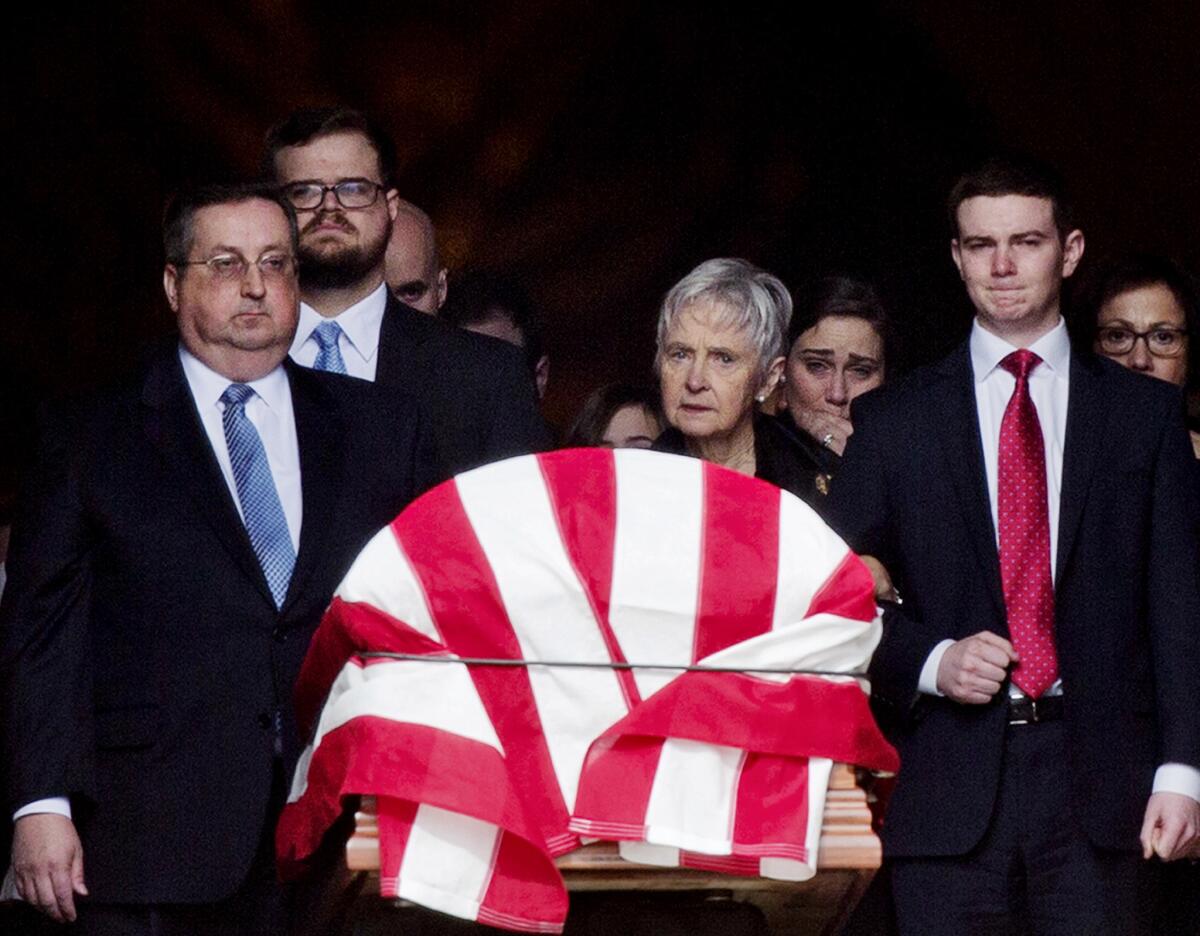 The casket of Supreme Court Justice Antonin Scalia leaves the Basilica of the National Shrine of the Immaculate Conception in Washington after his funeral Saturday, followed by his widow, Maureen McCarthy Scalia, and other family members.