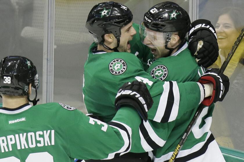 Stars defenseman Esa Lindell, right, is congratulated by teammates Jamie Benn and Lauri Korpikoski after scoring against the Kings in overtime Friday night.