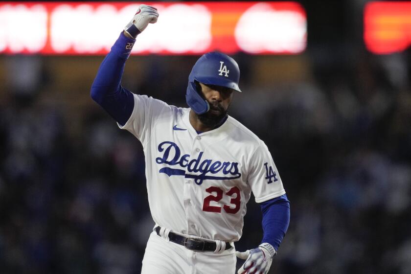Los Angeles Dodgers' Jason Heyward (23) celebrates as he rounds the bases after hitting a home run.