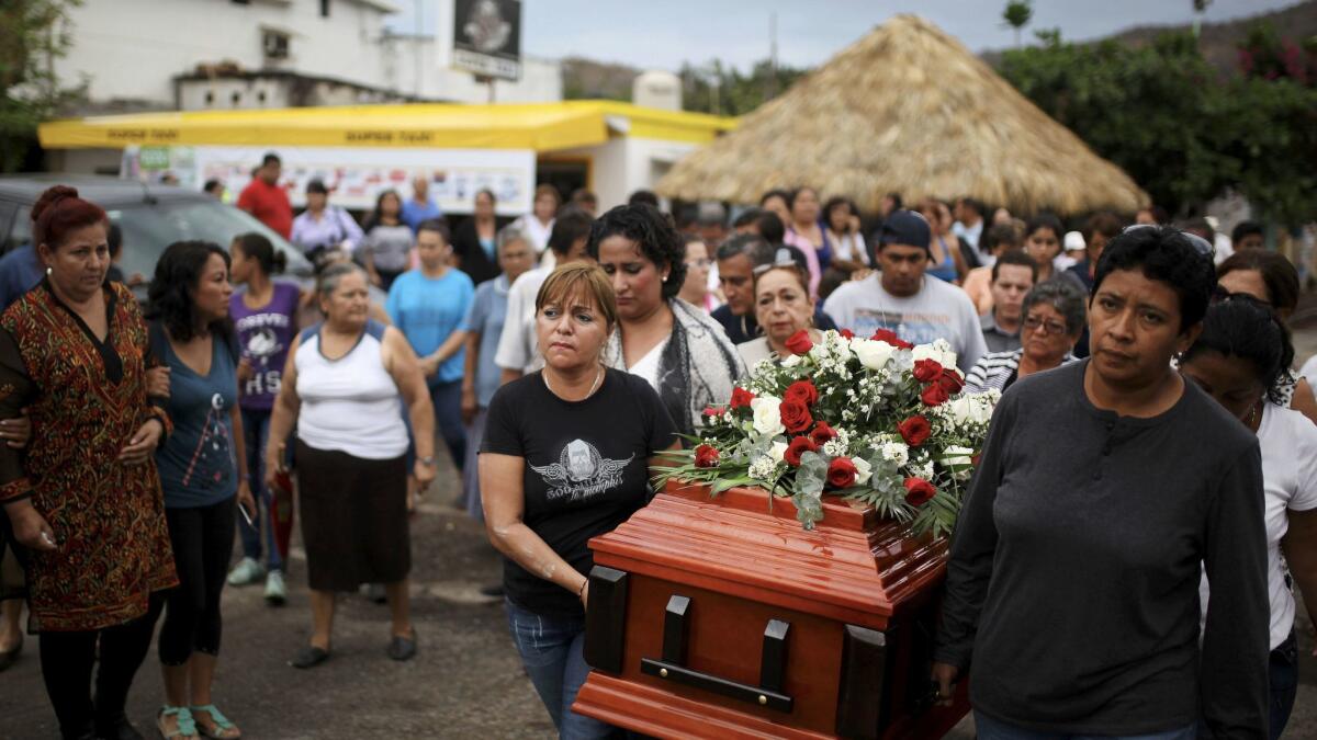 Members of the Colectivo Solecito search group carry the coffin of Pedro Huesca to a cemetery on March 8. The remains of Huesca, an investigator, were found in a mass grave and identified through DNA.