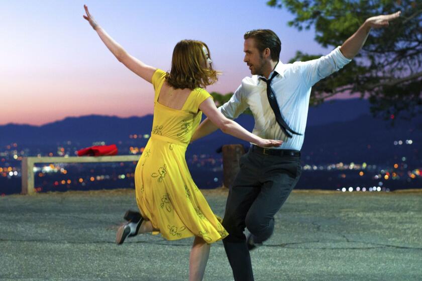 This image released by Lionsgate shows Ryan Gosling, right, and Emma Stone in a scene from, "La La Land." An instrumental overture that was cut from the hit musical film starring Ryan Gosling and Emma Stone will be added for a touring concert show that kicks off this month at the Hollywood Bowl. The âLa La Land In Concert: A Live-to-Film Celebrationâ is scheduled for 50 performances in the U.S. and internationally. (Dale Robinette/Lionsgate via AP)