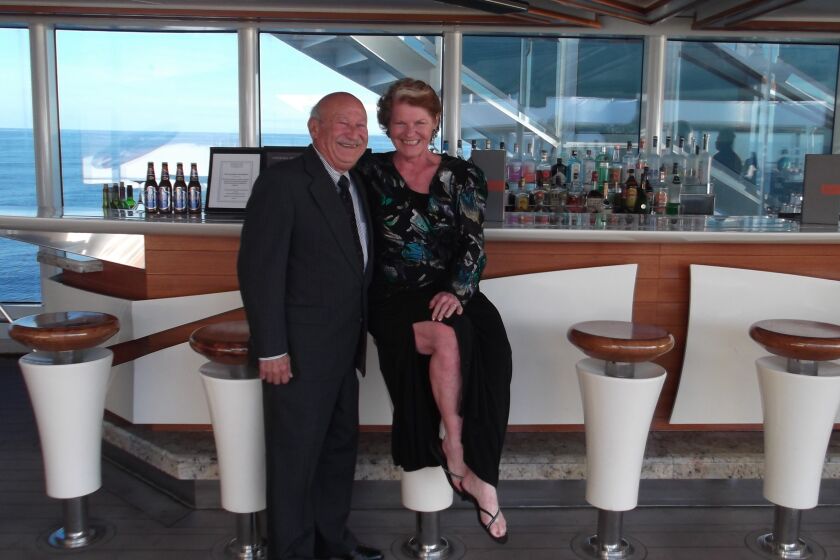 Marie Falcon and her husband pose on a cruise ship off the coast of France last March 2020