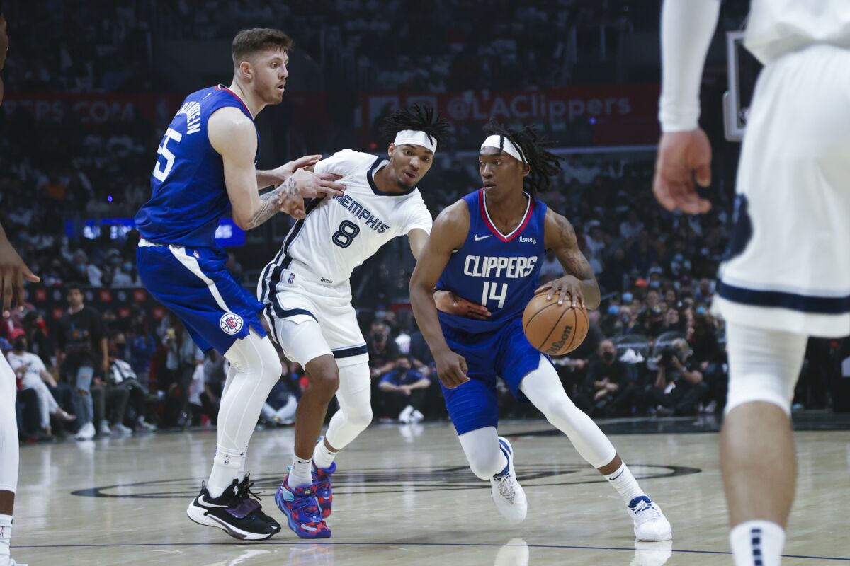 Clippers guard Terance Mann drives past Memphis Grizzlies forward Ziaire Williams.