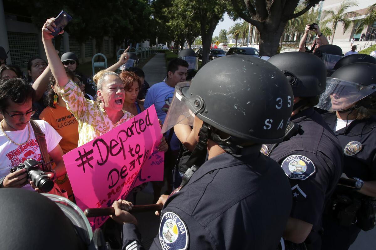 Protesters demonstrate in Santa Ana in 2014 over mistreatment of LGBT immigrant detainees at the at the country's only housing unit that ICE sets aside for gay, bisexual and transgender detainees. A new report says transgender detainees suffered abuse at the Santa Ana facility.