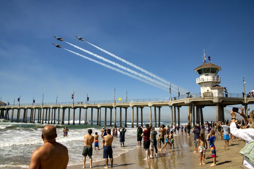 The U.S. Air Force Thunderbirds do a fly past over Huntington Beach Pier.
