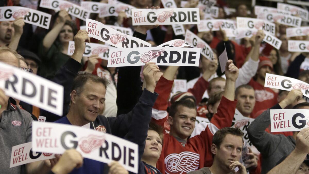 Fans wave "Get Well Gordie" signs for Detroit Red Wings legend Gordie Howe during a game between the Red Wings and Kings at Joe Louis Arena on Friday.