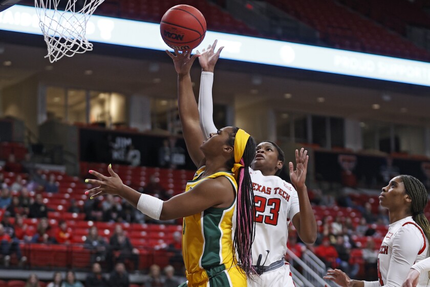 Baylor's Jordan Lewis (3) lays up the ball over Texas Tech's Khadija Faye (23) during the first half of an NCAA college basketball game on Wednesday, Jan. 26, 2022, in Lubbock, Texas. (AP Photo/Brad Tollefson)