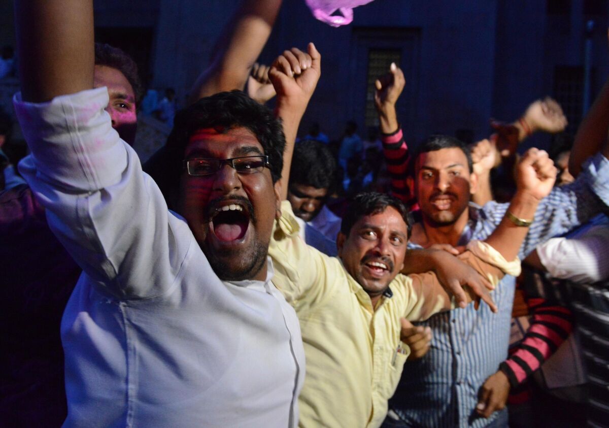 Osmania University students in Hyderabad celebrate after the announcement that India's ruling Congress Party had approved a resolution to create a new state called Telangana.