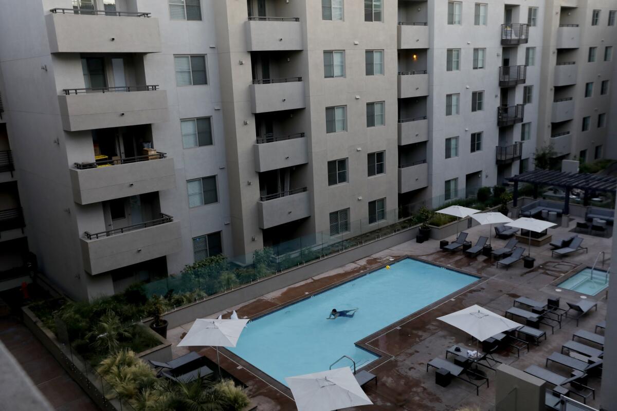 The pool and courtyard at an apartment building on Highland Avenue in Hollywood that includes short-term rentals is shown in mid-July.
